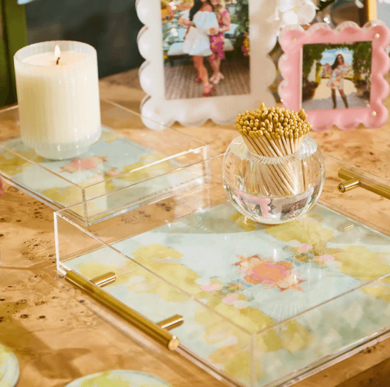 Clear acrylic tray with yellow, blue, and pink floral artwork and gold handles