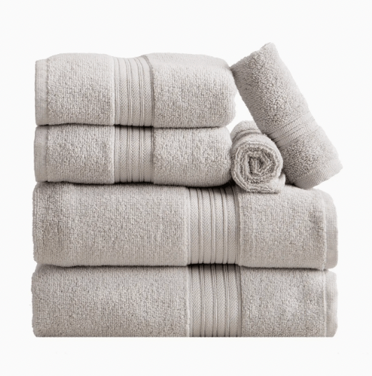 Beige monogrammed bath towel set styled folded and rolled, part of the monogrammed dorm bath bundle