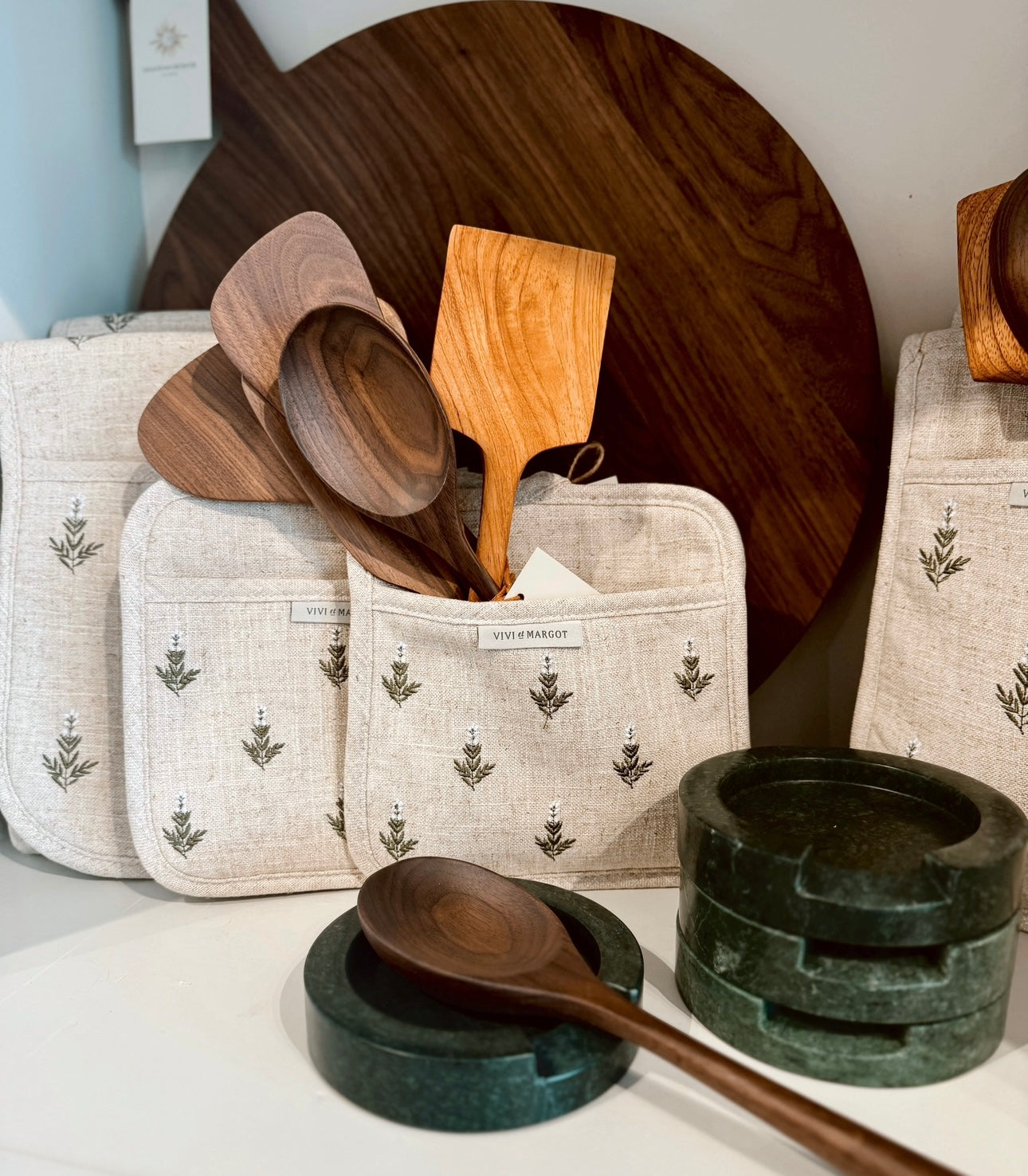 Canvas storage bag holding carved wooden utensil set pieces