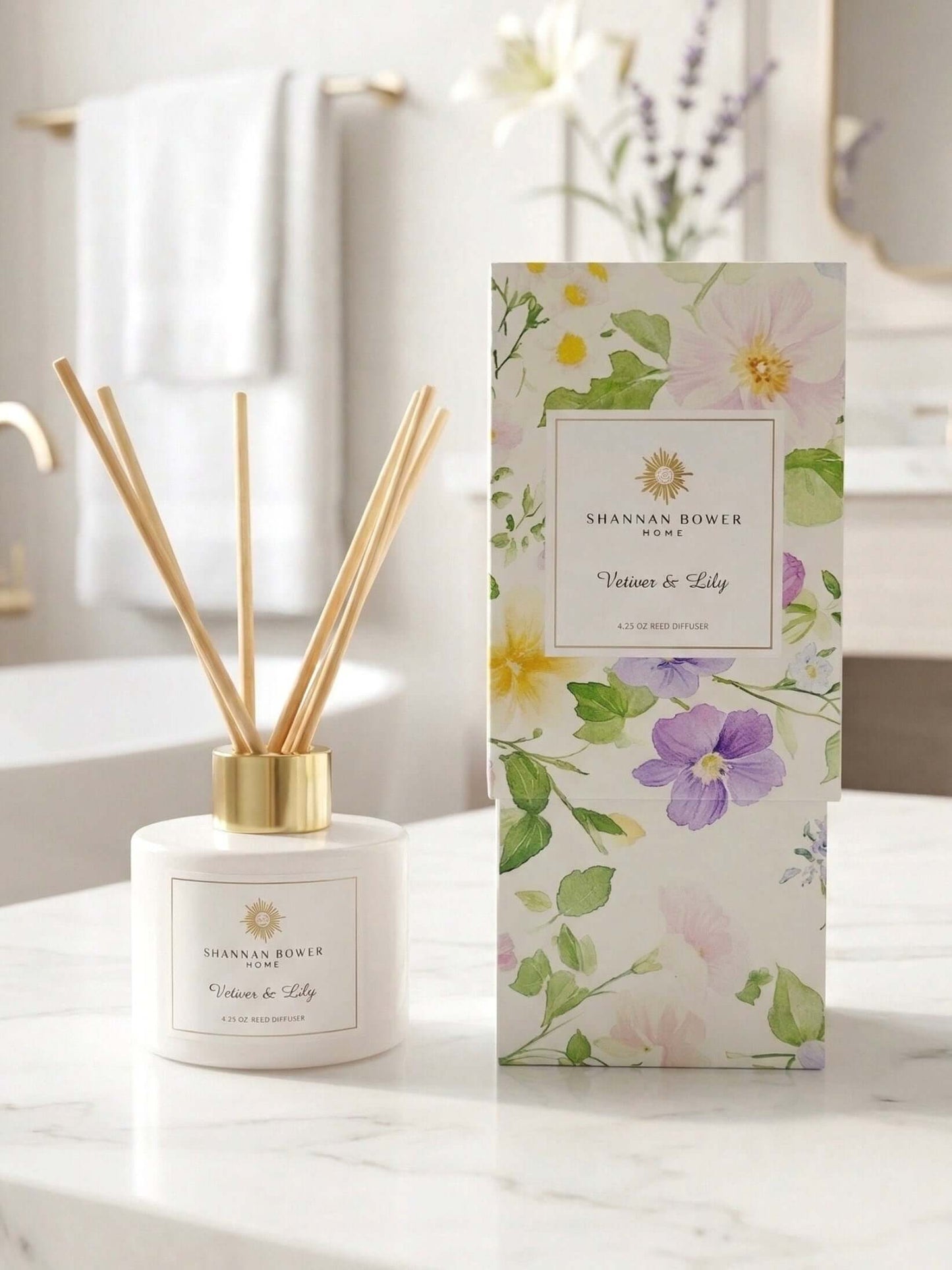 Diffuser with reeds and packaging on a marble surface