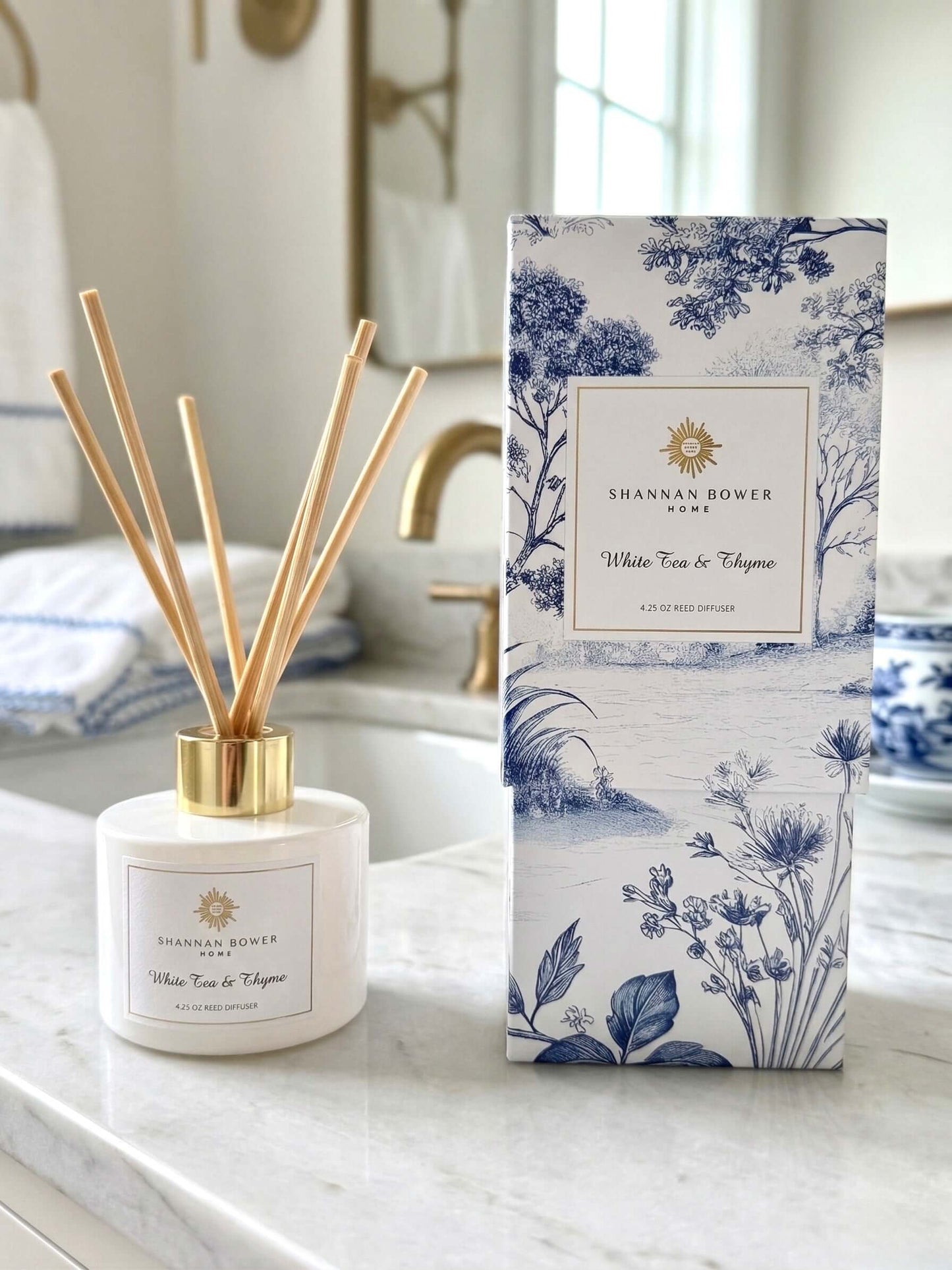 White Tea & Thyme Reed Diffuser on marble countertop in luxurious bathroom
