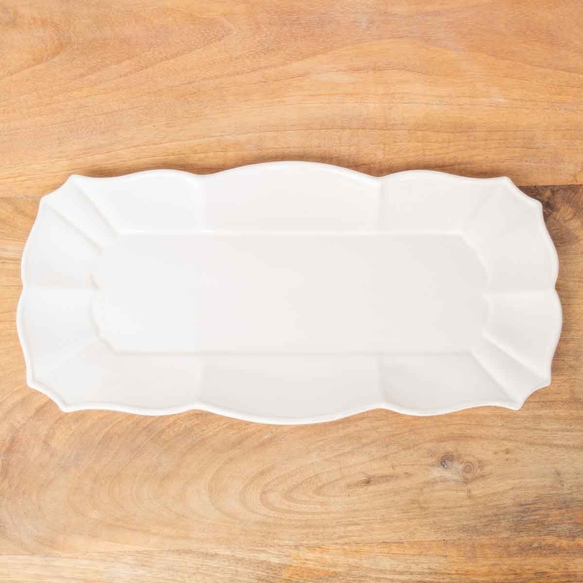 White serving tray on a wooden background.