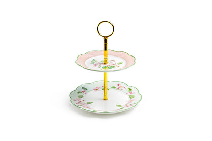 Two-tiered ceramic cake stand with floral design on a white background