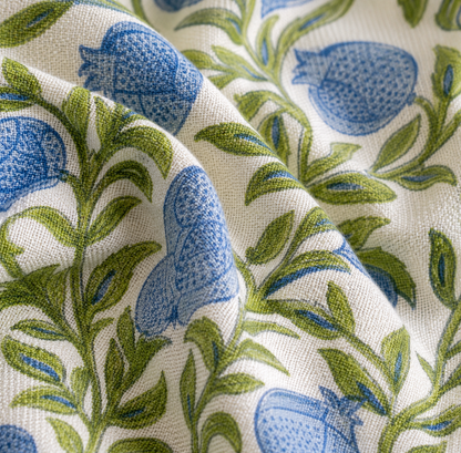 Blue Pomegranate Apron Fabric with blue floral and green leaf pattern on a white background