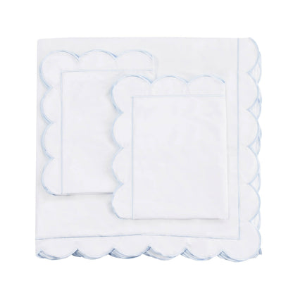 White scalloped edge napkin on a white background