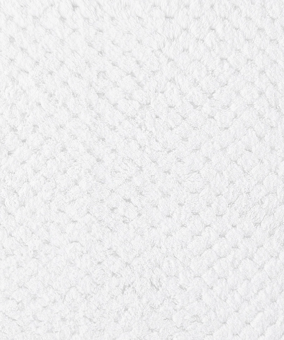 Product detail image of a cotton bath mat showcasing texture, craftsmanship, and design features