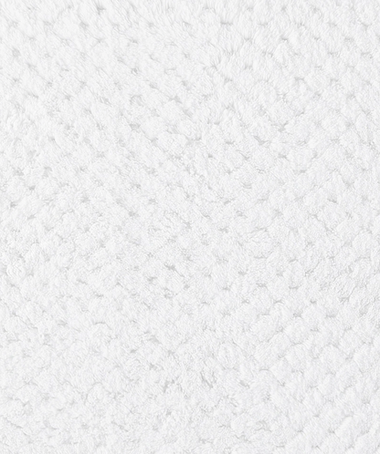 Product detail image of a cotton bath mat showcasing texture, craftsmanship, and design features