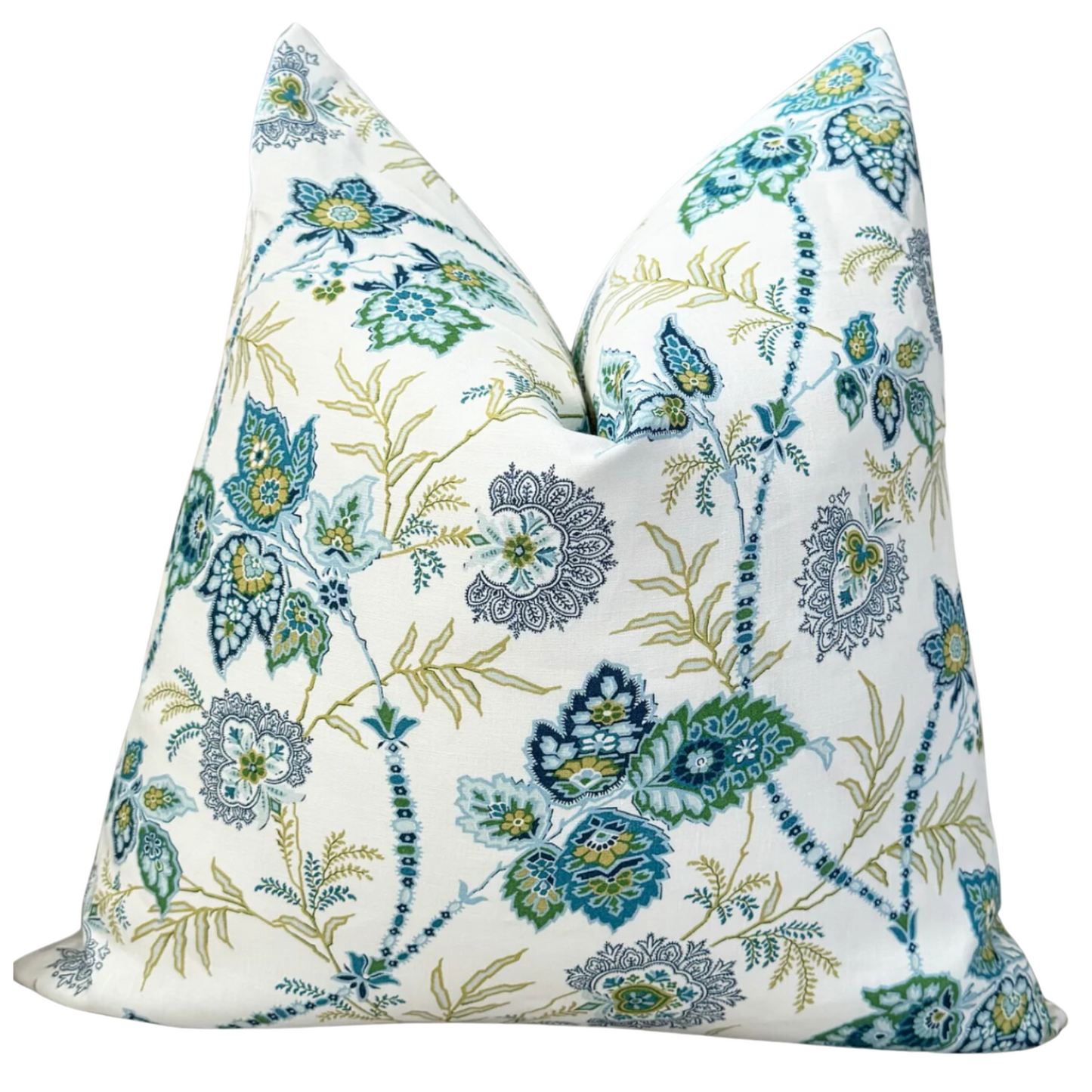 A decorative throw pillow with a floral pattern in blue, green, and white colors, featuring a linen front and backing with an exposed brass zipper.