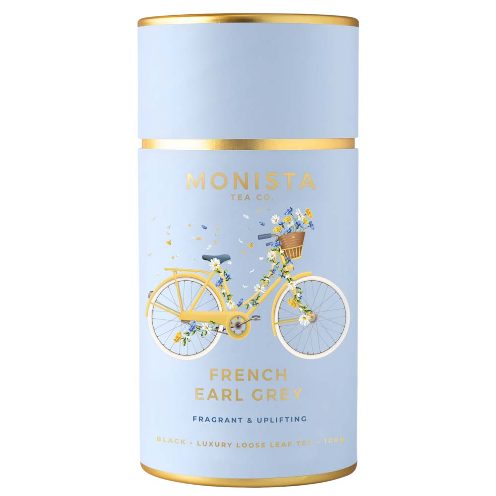 Tea canister with a bicycle illustration and 'Monista Tea Co' branding on a light blue background.