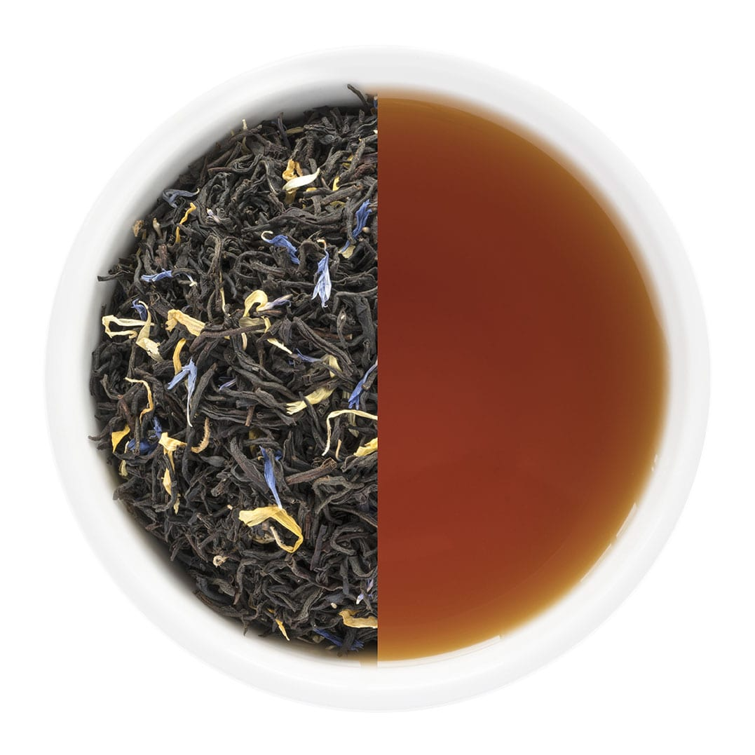 Tea leaves and brewed tea in a white bowl on a white background