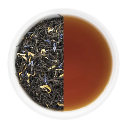Tea leaves and brewed tea in a white bowl on a white background