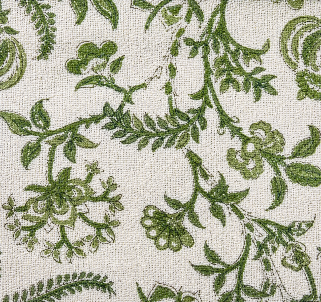Green floral pattern on a textured beige background