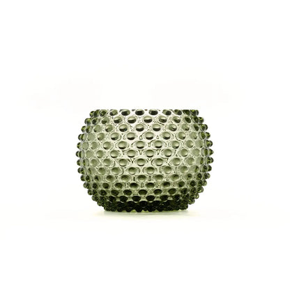 A small textured glass candle holder with a bubble or honeycomb pattern, shown on a plain white background.