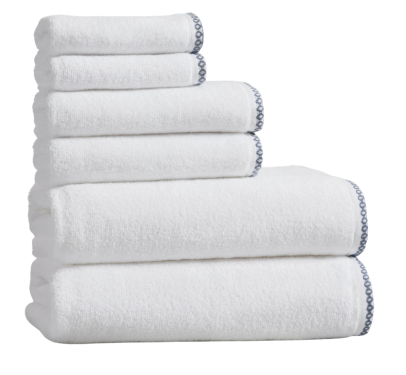 Stack of white towels with a chain detail on a white background
