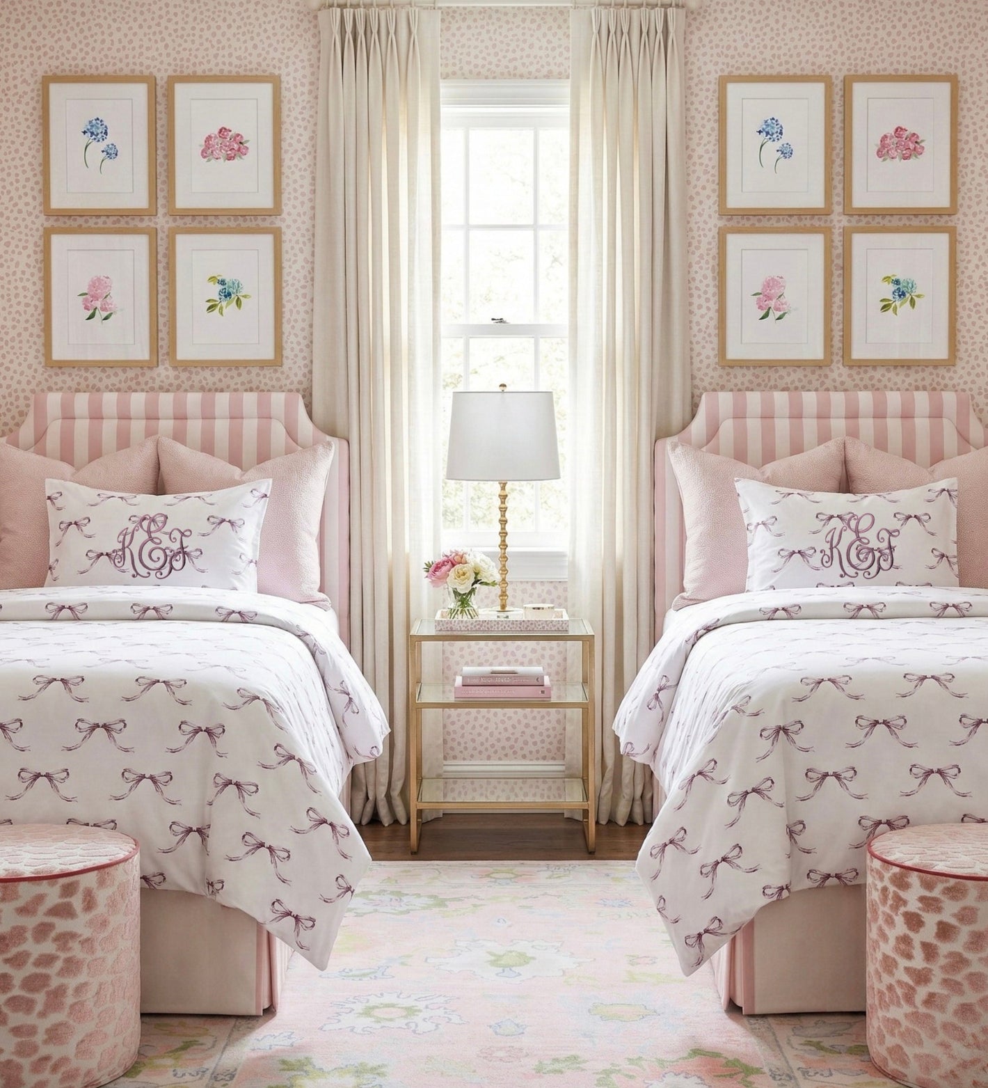 Two beds in a bedroom with matching headboards, bedding, and decor.