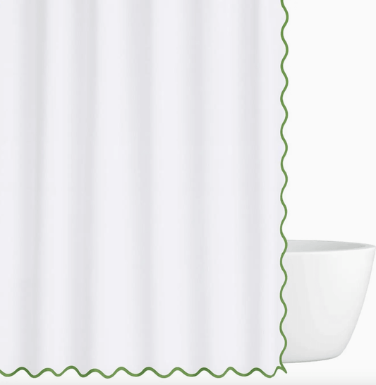 green scalloped shower curtain with green trim on a white background