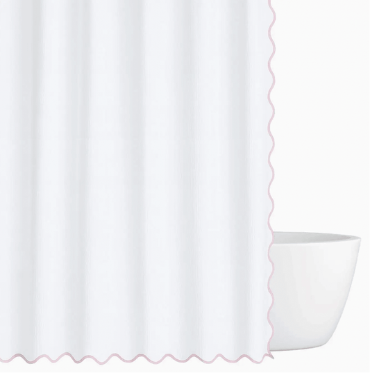 Pink scalloped shower curtain on white background
