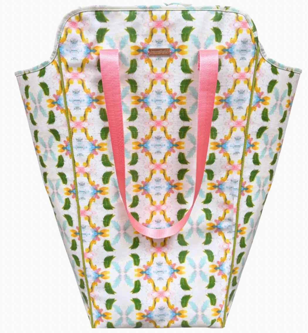 Patterned bag with pink handles on a white background