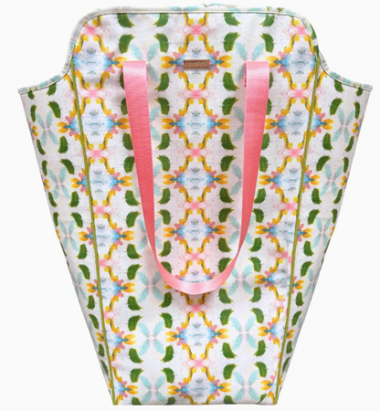 Patterned bag with pink handles on a white background