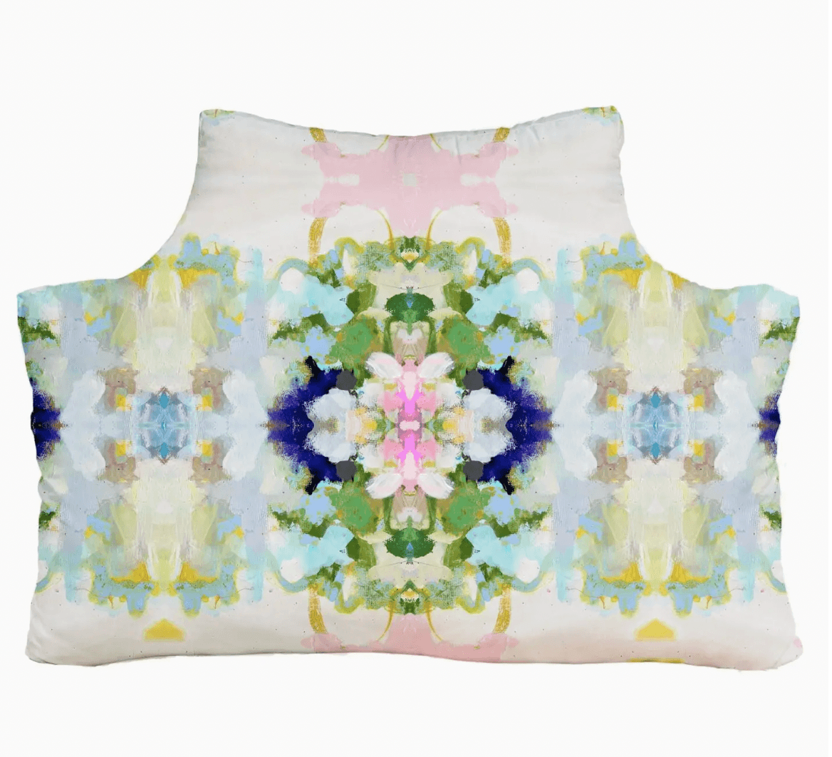 Decorative headboard pillow with a colorful floral pattern on a white background