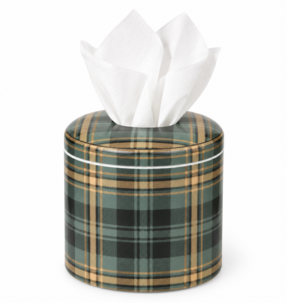 A cylindrical tissue box cover with a green, black, and tan plaid pattern, shown with white tissue paper protruding from the top against a plain white background.