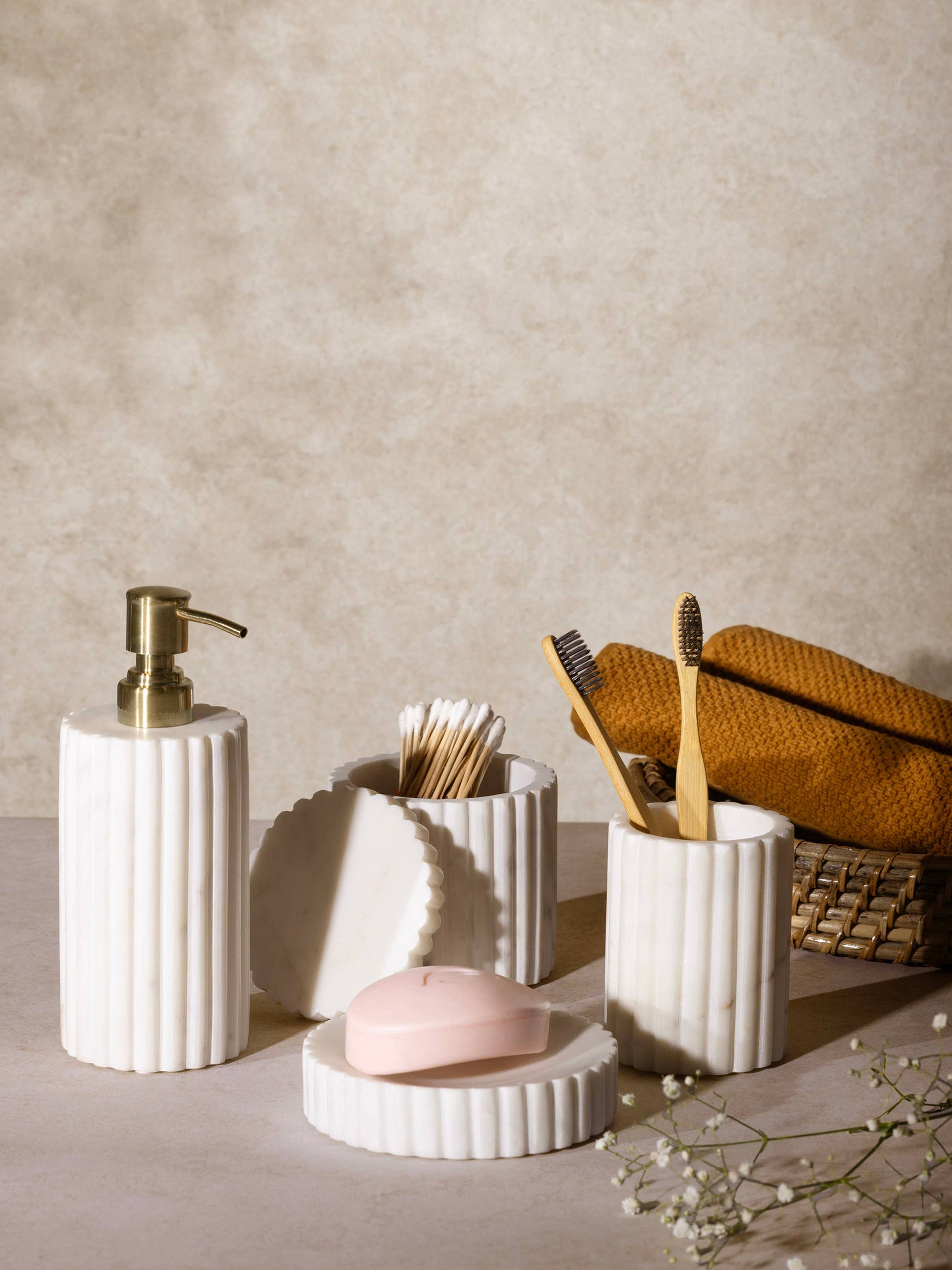 Fluted marble bath accessory set with soap dispenser, toothbrush holders, and soap dish