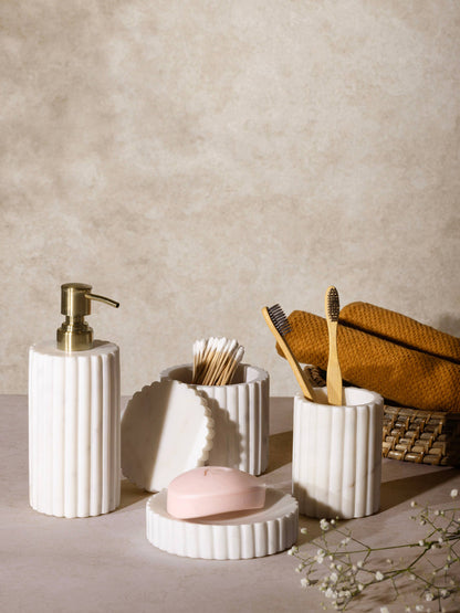 Fluted marble bath accessory set with soap dispenser, toothbrush holders, and soap dish
