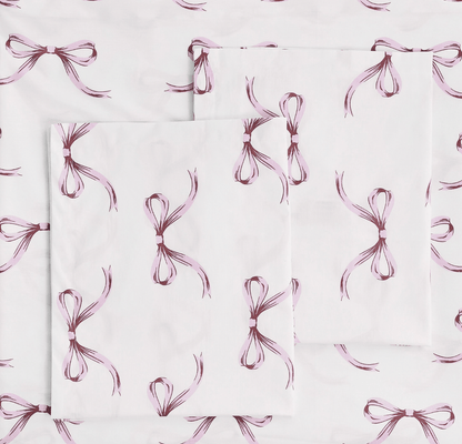 Pattern of pink bows on a white background