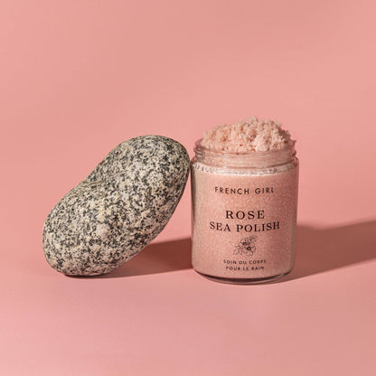 Jar of French Girl Rose Sea Polish with a stone on a pink background