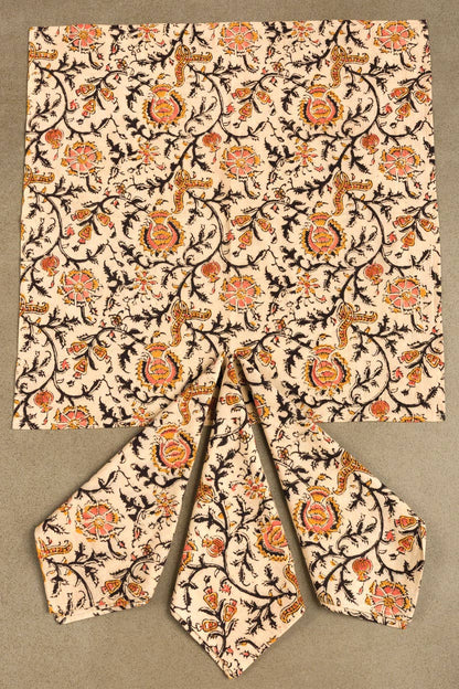 Light cream dinner napkin with ornate rose print, square top with folded wedge pieces