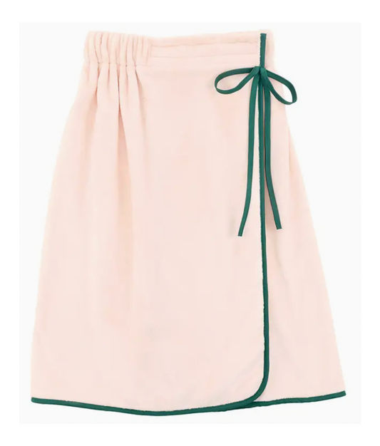 Beige towel with green trim and tie on a white background