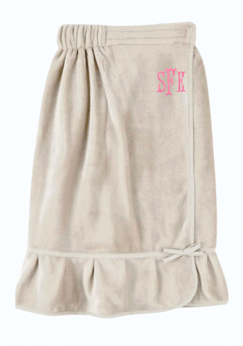 Beige bath spa wrap with pink monogram on a white background with a monogram in light pink.