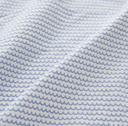  white percale sheet sets with blue stripes on the edges, neatly folded.