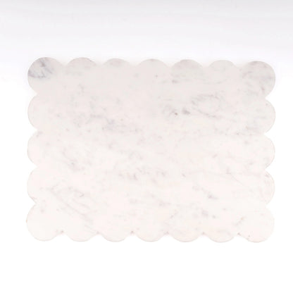 A rectangular white marble tile with scalloped edges, showing subtle gray and soft beige veining, set against a plain white background.