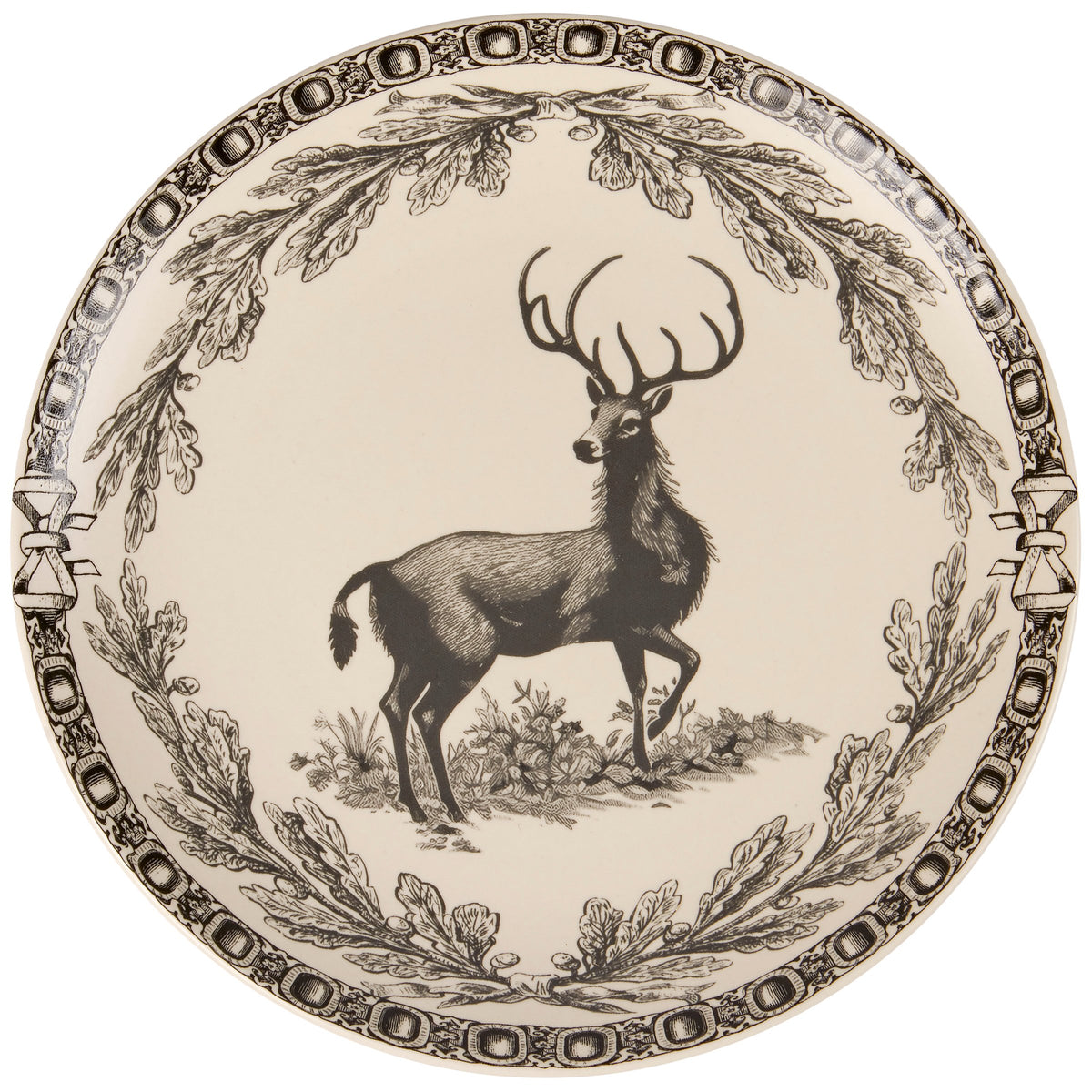A round decorative plate featuring a black engraved deer with antlers surrounded by an oak leaf wreath border on a warm cream background.